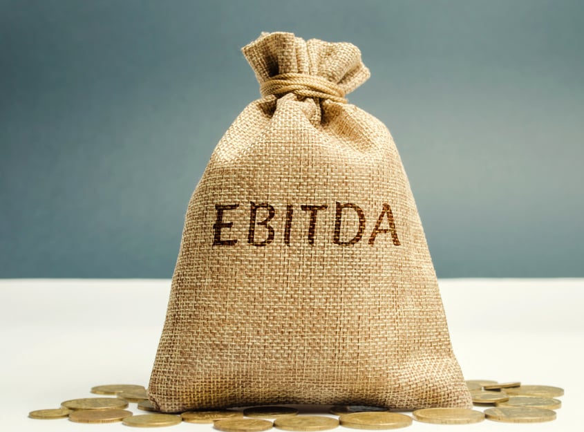 Money bag with the word Ebitda. Earnings before interest, taxes, depreciation and amortization. Financial result of the company. Cash flow estimate. Financial performance ratio. Pretax profit.