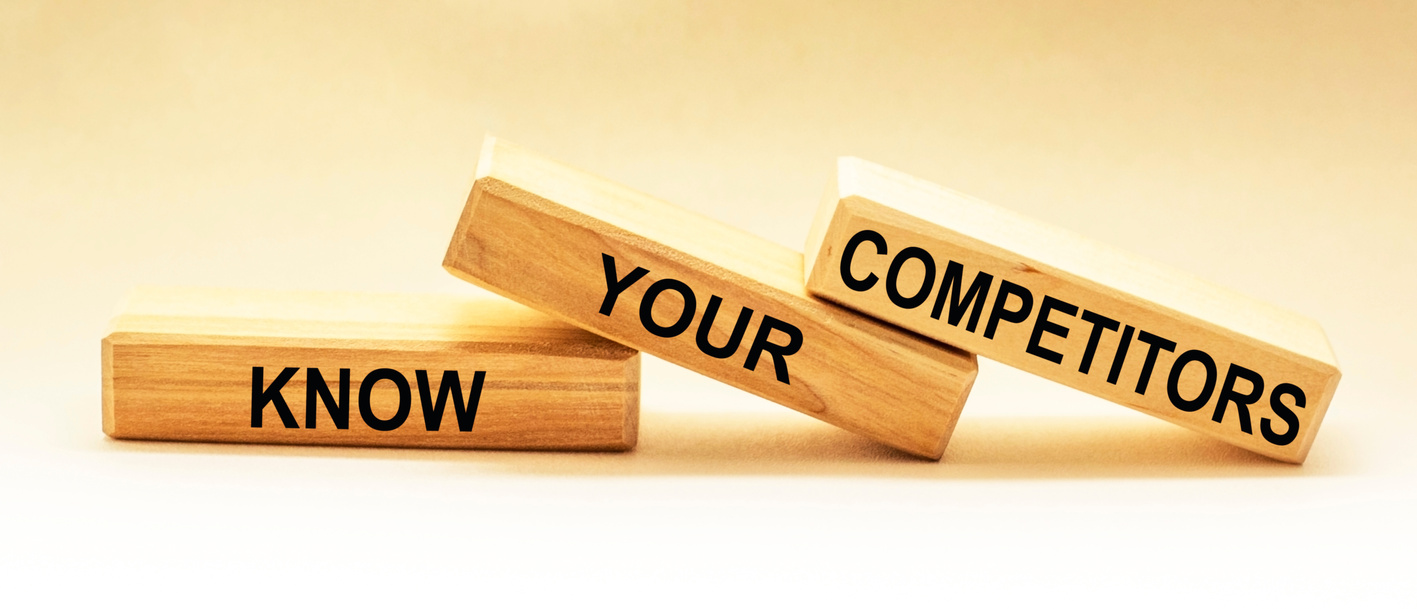 On wooden blocks the text KNOW YOUR COMPETITORS concept of business success.