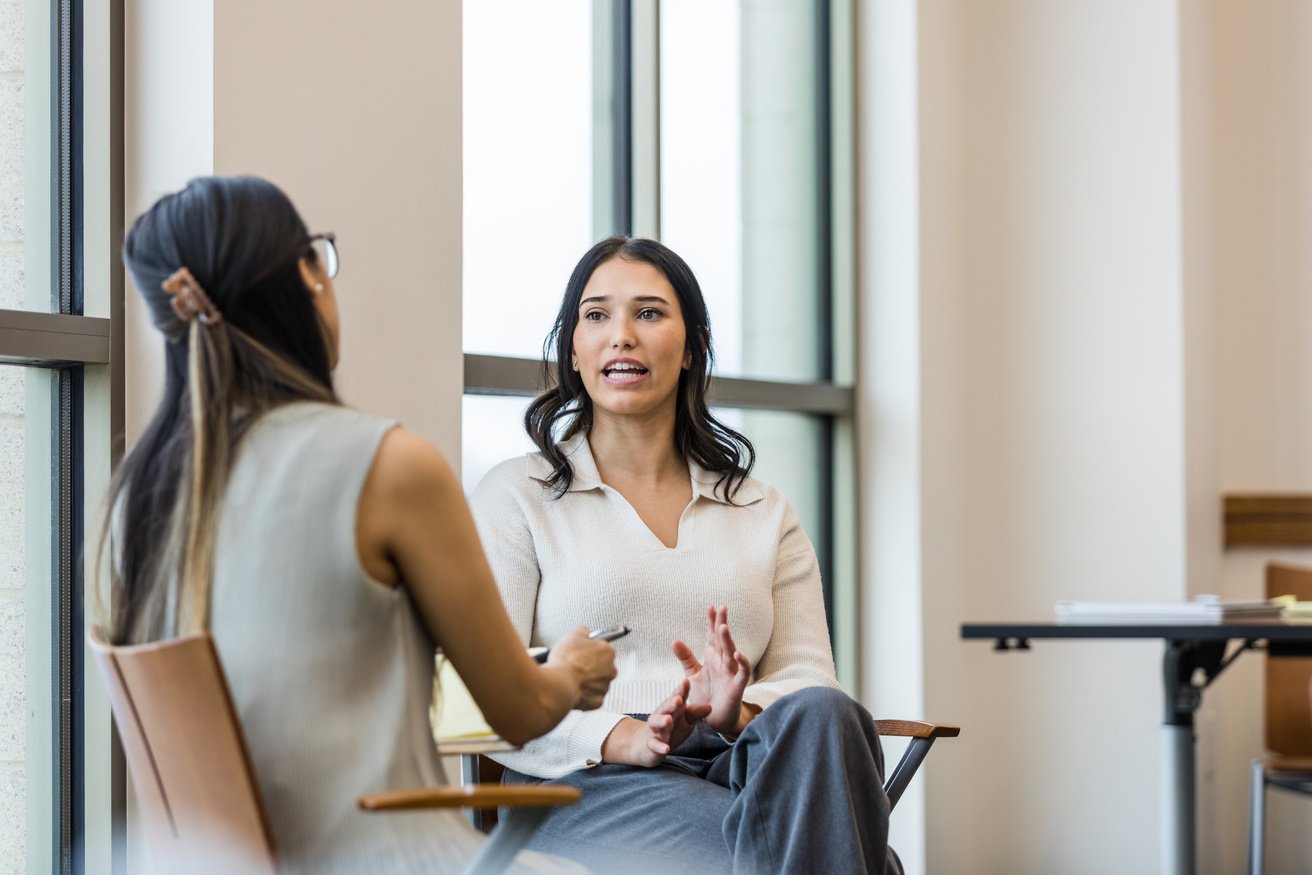 Concerned female employee meets with the benefits coordinator